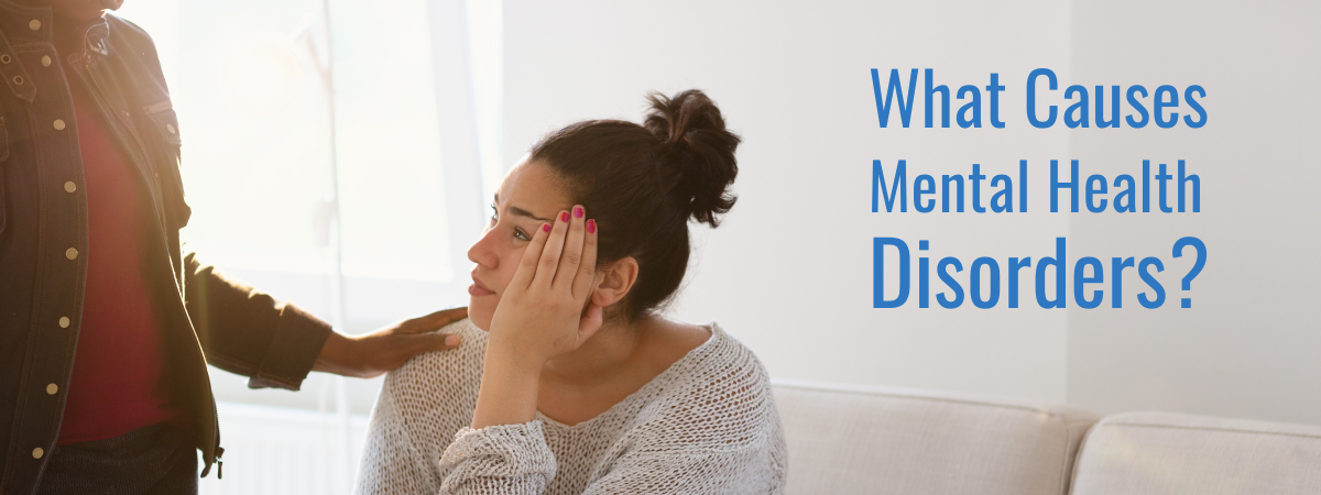 two women talking by a couch with a text overlay of what causes mental health disorders